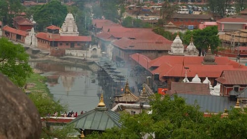 Cityscape view of Kathmandu, Nepal, during a cremation ritual in Pashupatinath Hindu Temple, next to