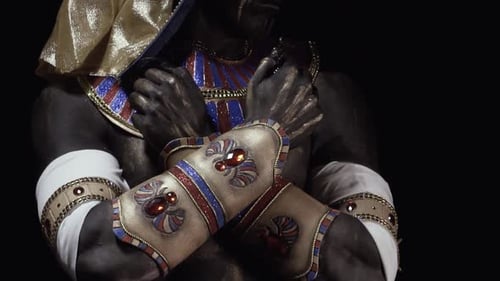 Long claws of Anubis, ancient egyptian clothes with jewelry, close up