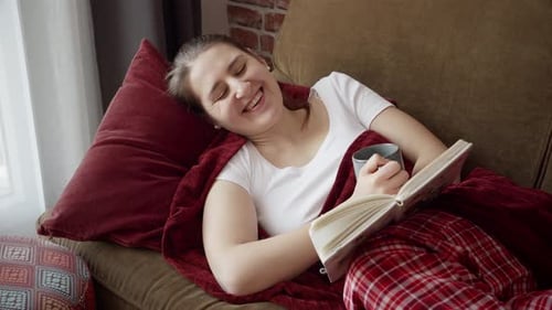 Woman Relaxing on Couch Reading a Book