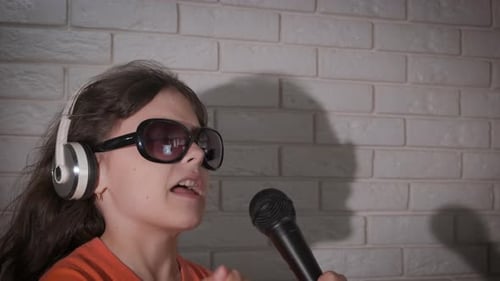 Child Singing with Microphone and Headphones