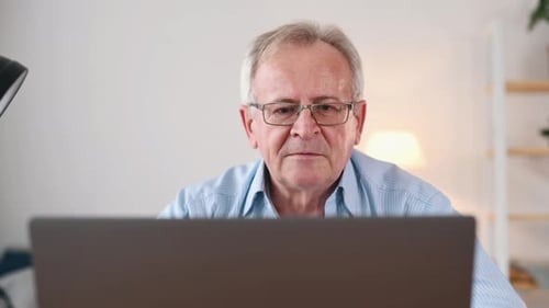 Man Using a Laptop Computer Indoors