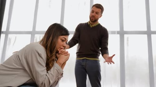 Couple Having Difficult Conversation Indoors During Daytime
