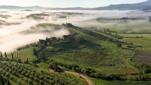 Aerial view of Tuscany's farms and fog, Italy.