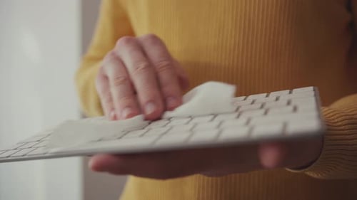 Coronavirus Cleaning COVID19 Pandemic Closeup Man Cleaning Office Laptop Keypad with Antibacterial