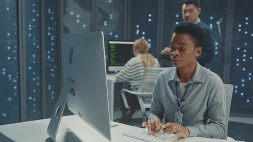 Woman Working at Computer in Server Room