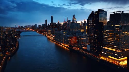 Drone footage above the river in New York at night.