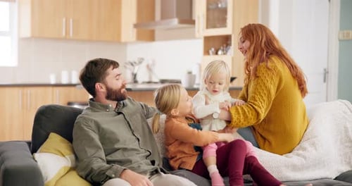 Happy Family Relaxing Together on Couch at Home