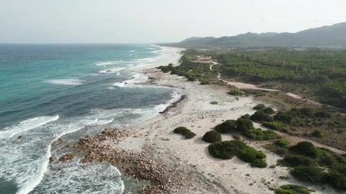 Aerial view drone over beach sea with powerful sea waves. Beach sand and amazing sea in summer. Sard