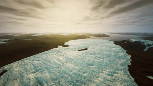 Aerial Flight Over Vast Glacier and Icy Mountain Landscape