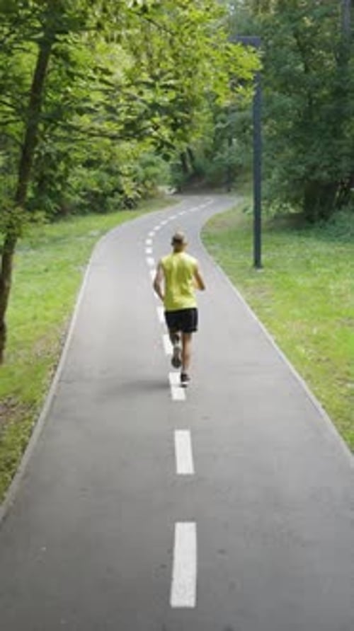 Vertical Screen Man Jogging on Road with Marking