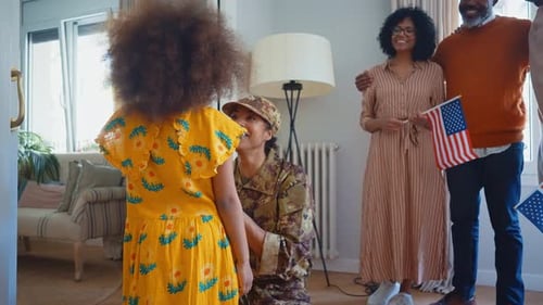 Soldier Returns Home to Family with American Flags