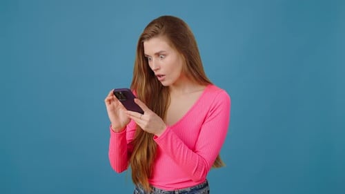 Woman Using Cell Phone With Emotional Reactions