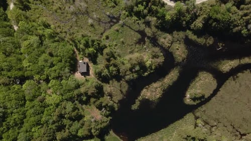 Bird's Eye View Of The Lake House Surrounded By Green Trees. aerial