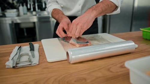 The process of cooking breaded chicken The chef cuts the chicken fillet with a knife Professional