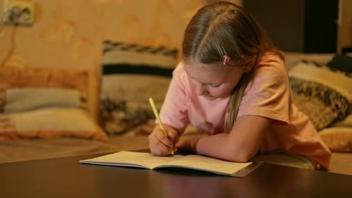 Diligent Girl Doing Homework in Living Room at Night