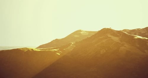 Majestic Mountain Landscape During Golden Hour with Soft Sunlight