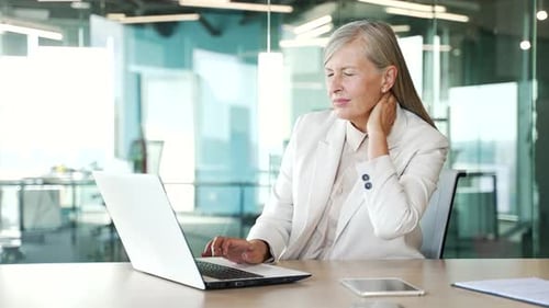 Woman Typing at Laptop Experiences Neck Pain