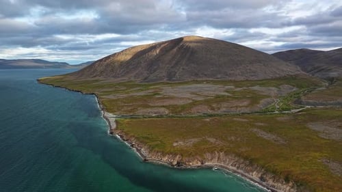 Drone Cinematic Shot Drift Over Turquoise Sea and Headland Gilmimyl Chukotka