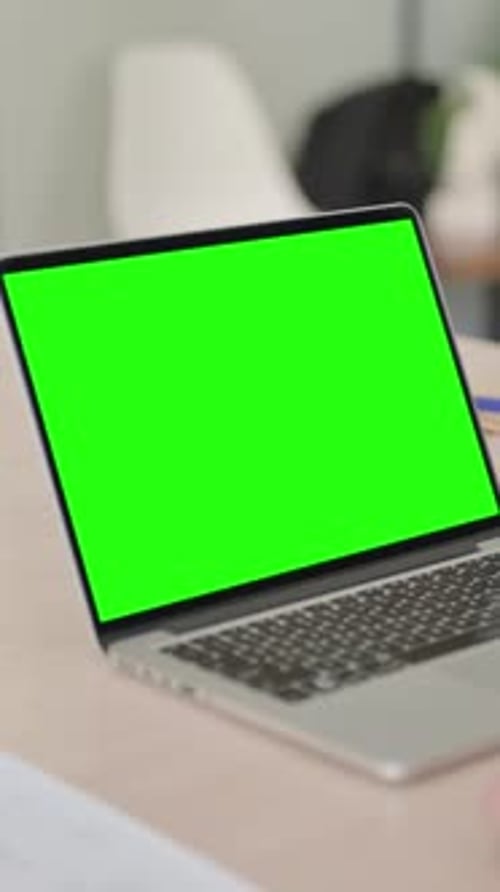 Man Using Laptop with Green Chroma Screen, Vertical Video