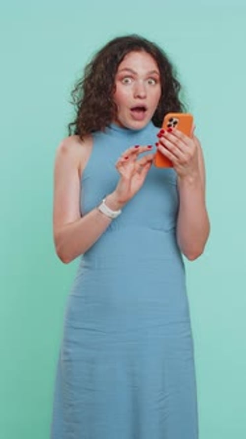 Woman Celebrates Success with Smartphone