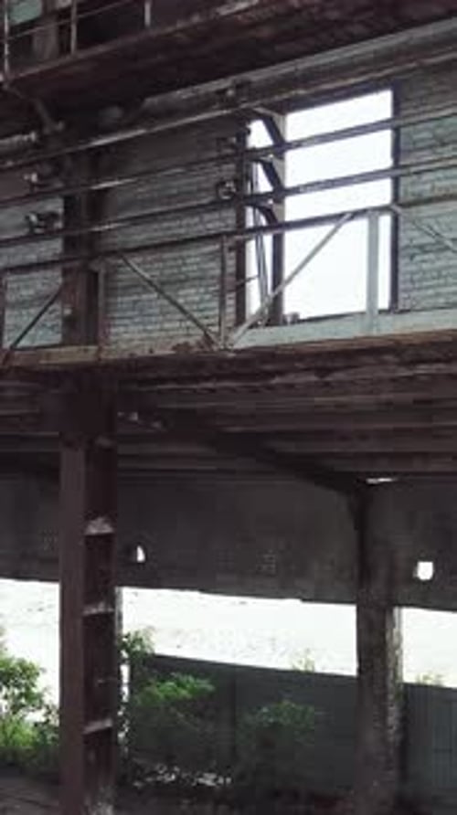 Aerial view of a destroyed factory during the war. Industry in ruins. Vertical video