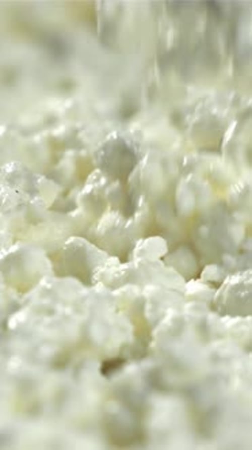 Fresh Cottage Cheese Falls Into the Bowl Filmed on a Highspeed Camera at 1000 Fps