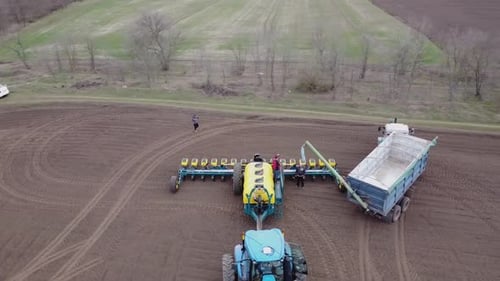 Blue tractor OA working on the field in Ukraine