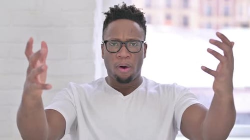 Upset Man Frustrated and Gesturing Indoors