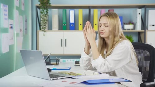 Stressed Woman Working at Laptop in Office