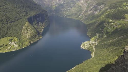 Majestic aerial view of Geirangerfjord’s famous Seven Sisters waterfalls and surrounding mountains