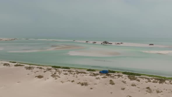 Aerial View Of Serene Remote Beach And Turquoise Waters In Bar Al aerial-view-of-serene-remote-beach-and-turquoise-waters-in-bar-al