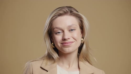 Smiling woman with blond hair wearing blazer