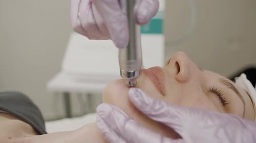 Exploring cosmetology techniques with permanent makeup application on a girl in a beauty studio