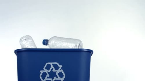 Plastic Bottles Thrown into Blue Recycling Bin