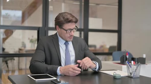 Waiting Middle Aged Businessman Checking Time on Wrist Watch in Office