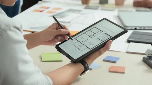Architect Using Tablet to Review Building Plan