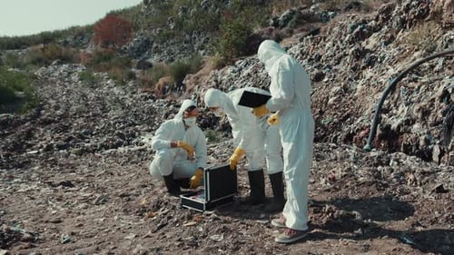 Workers in Protective Suits Study Landfill Pollution