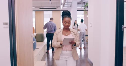 Woman Uses Tablet in a Modern Office Setting
