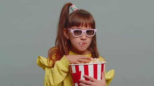Cute Girl Enjoys Popcorn Wearing 3D Glasses