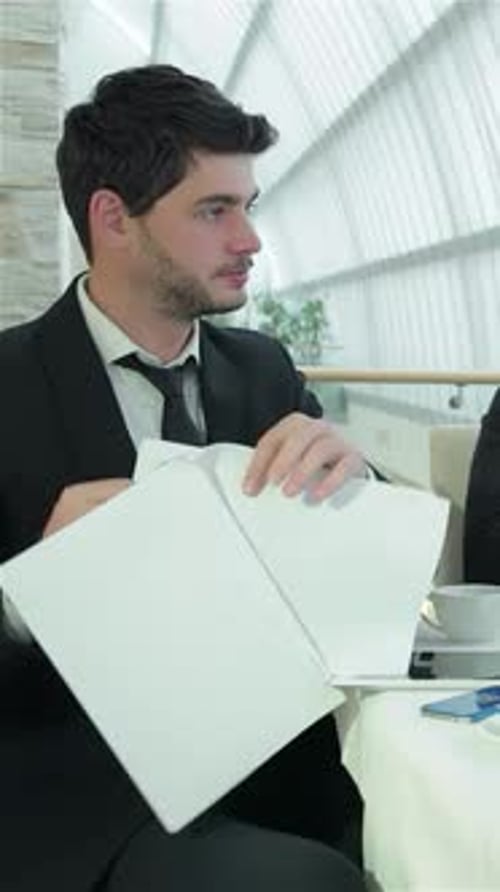 Engaging Teamwork Among Four Smiling Businessmen in a Sleek Modern Office