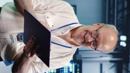 Man Writing on Clipboard in Futuristic Office