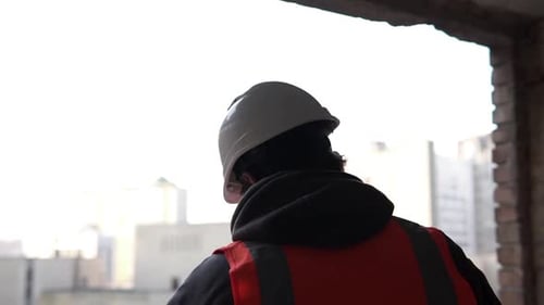 A construction engineer is looking at working drawings of a high-rise building.