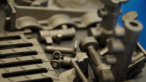 Closeup of Gray Metal Castings and Machined Components on a Display Showing Circular Finned Discs