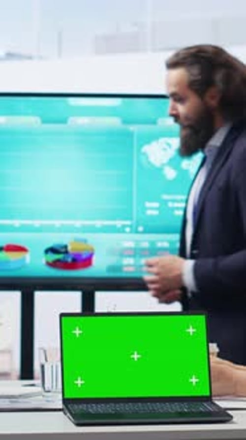 Vertical Video Broker Showing Stock Exchange Charts on Chroma Key Laptop