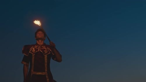 Young Adult Performing Fire Breathing Stunt at Night