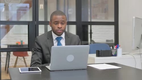 Young Adult Man in Video Conference Meeting at Office