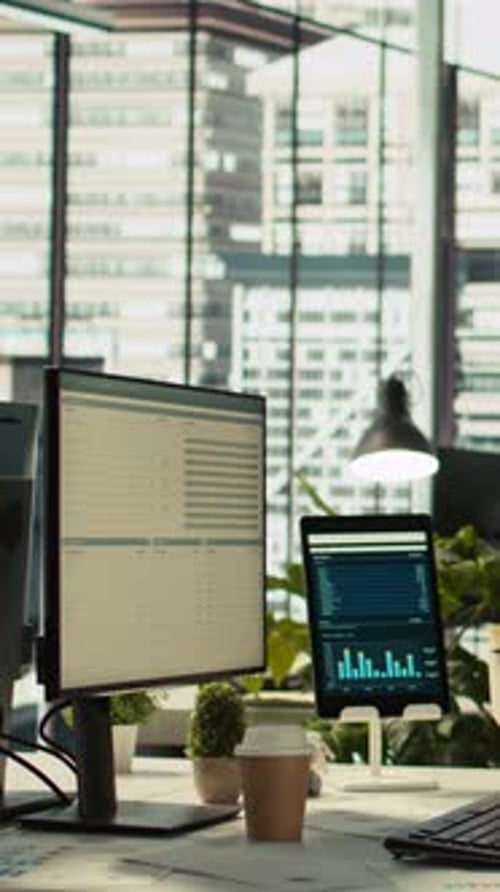 Vertical Video Financial Charts and KPI Metrics on Displays in Office