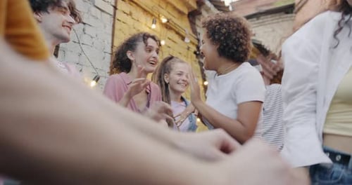 Energetic Friends Dancing at an Outdoor Party