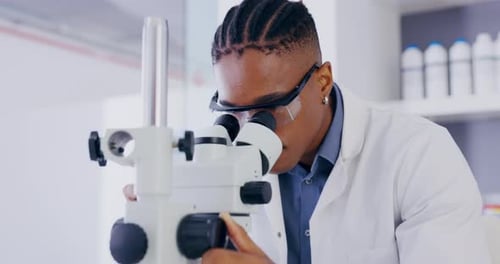 Scientist Using Microscope in Modern Laboratory