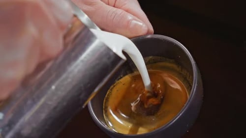 Pouring Steamed Milk Into Espresso For Latte Art